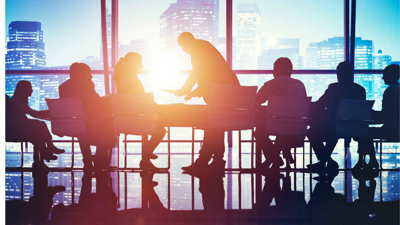 Leadership team meeting in a boardroom at sunset